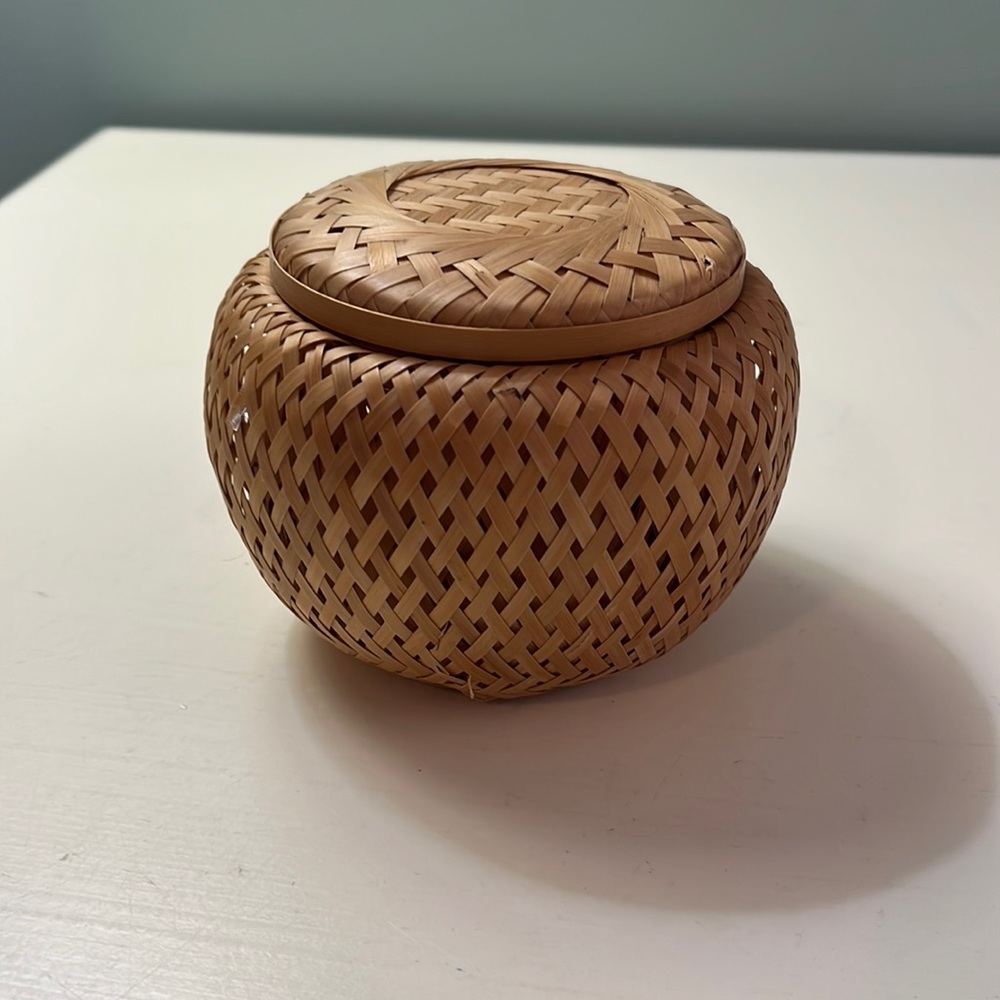 Small round woven container with lid.